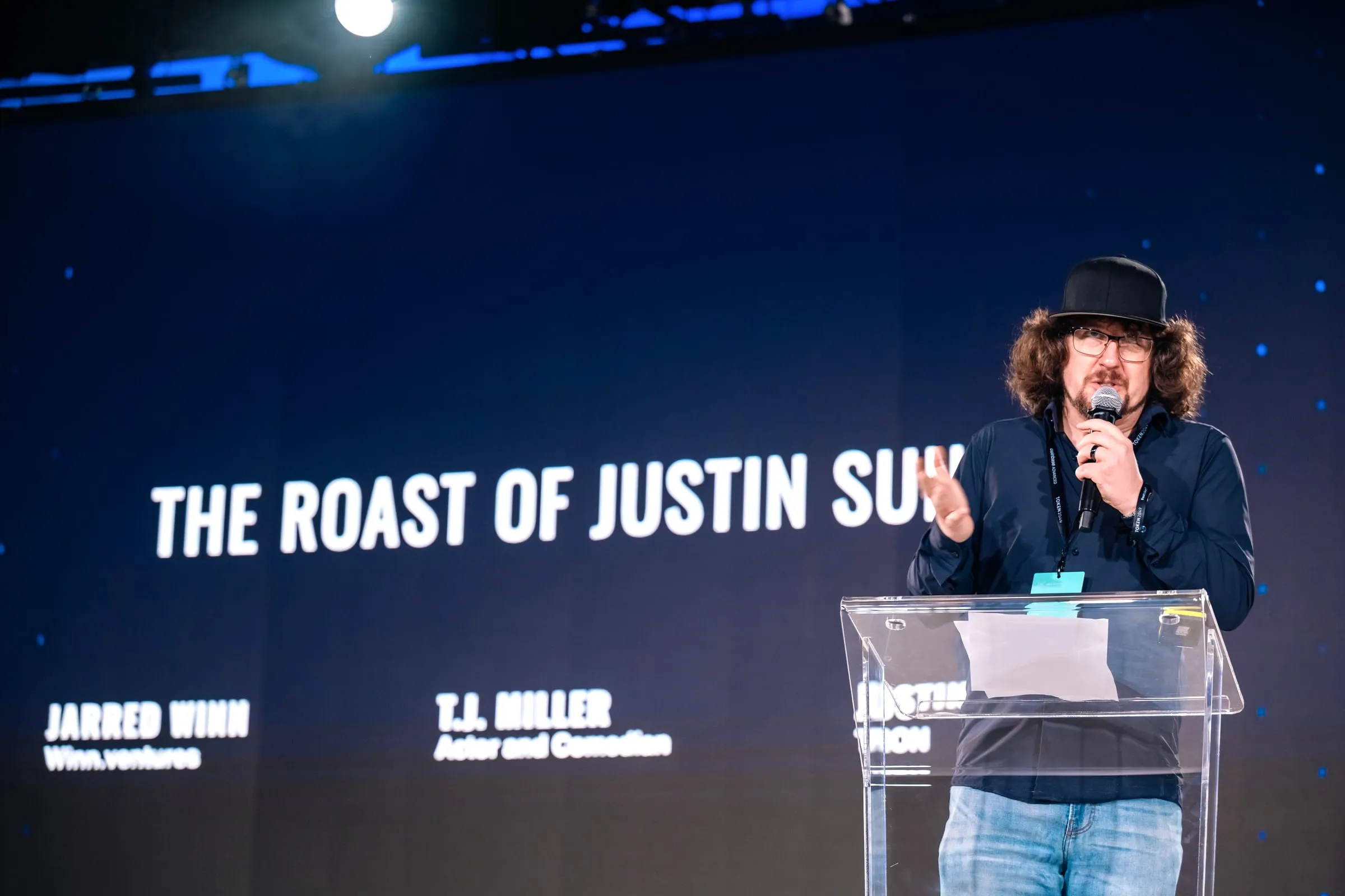 Jarred Winn at the podium of the Roast of Justin Sun